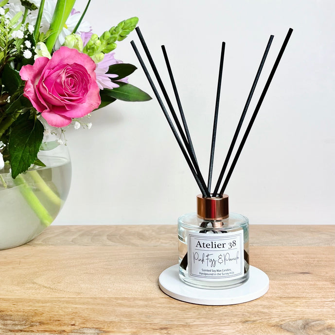Glass diffuser bottle with black fibre reeds, scent of Pink Fizz and Pomelo